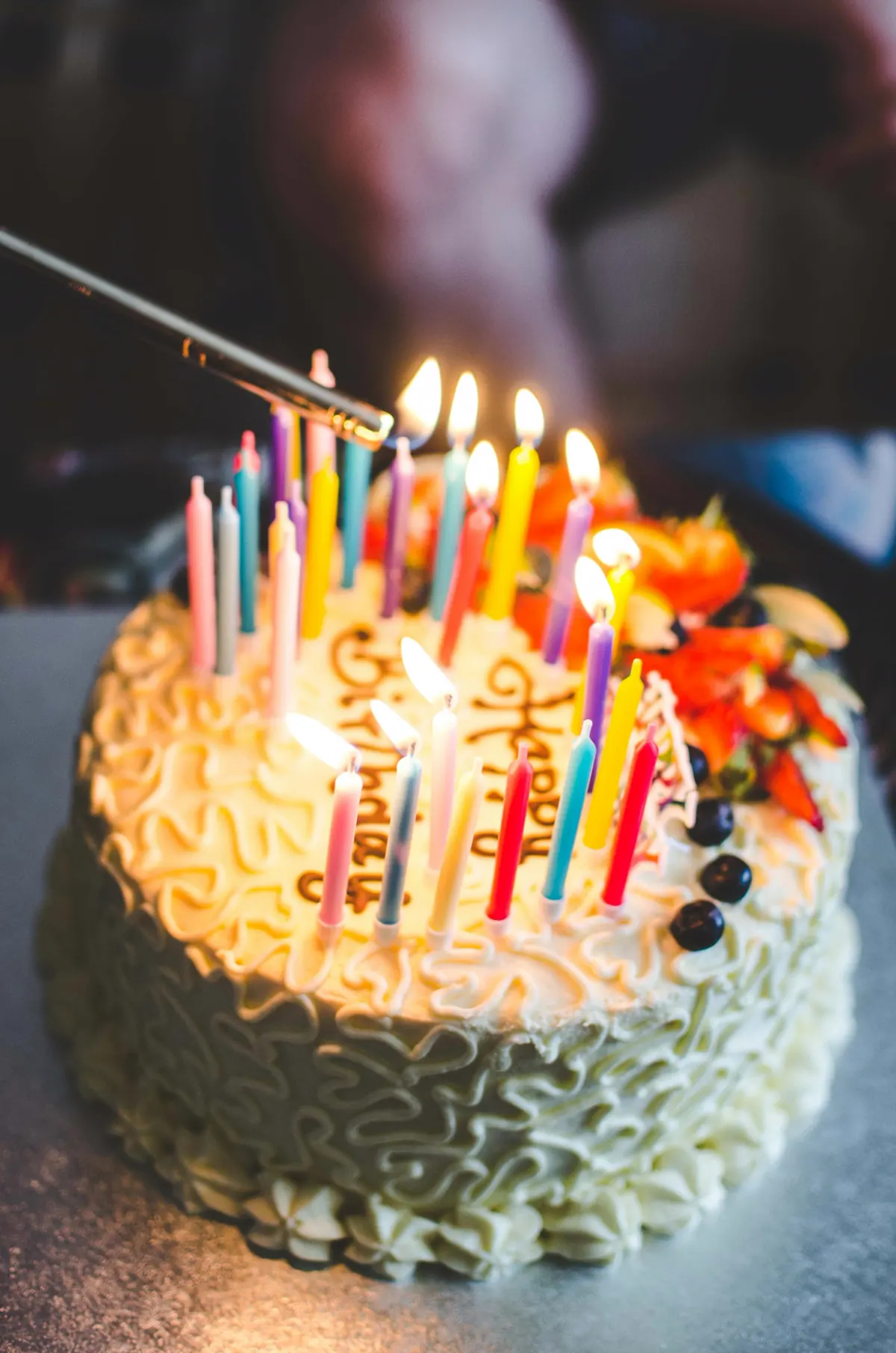 A birthday cake carrying lit candles.
