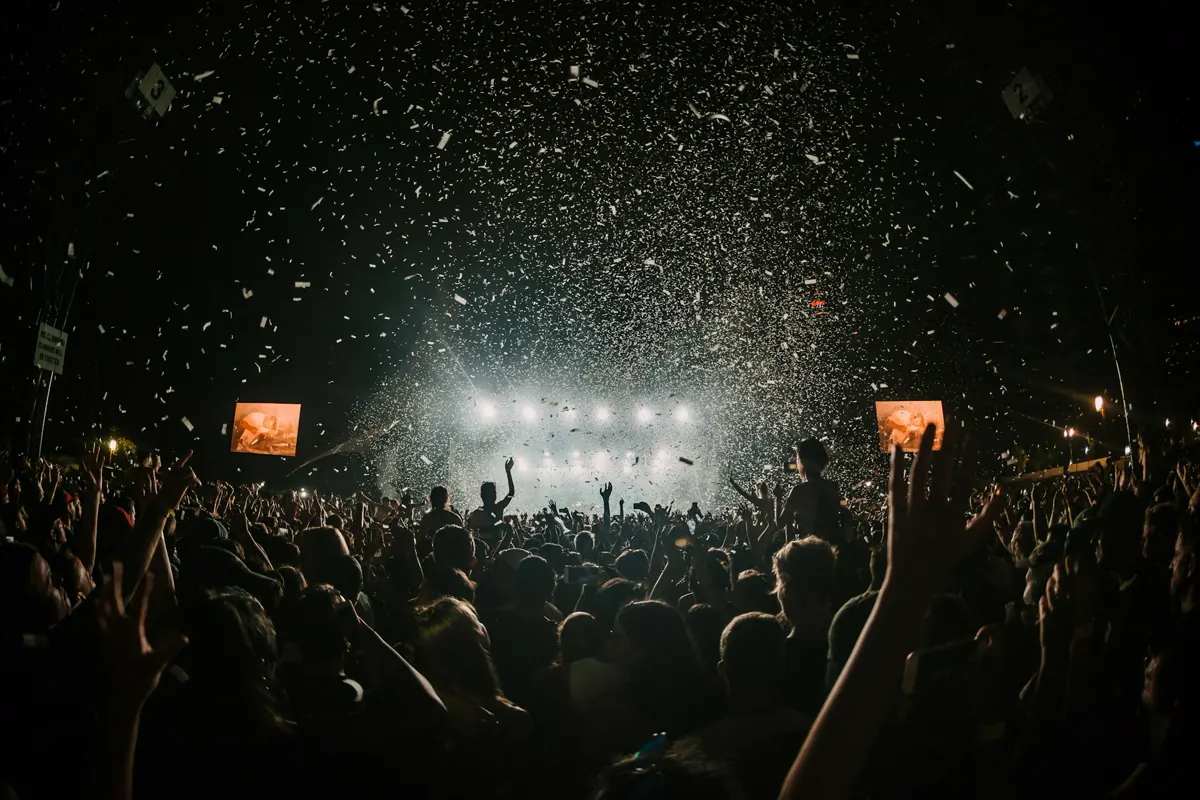 A crowd spread across an open field at a concert.