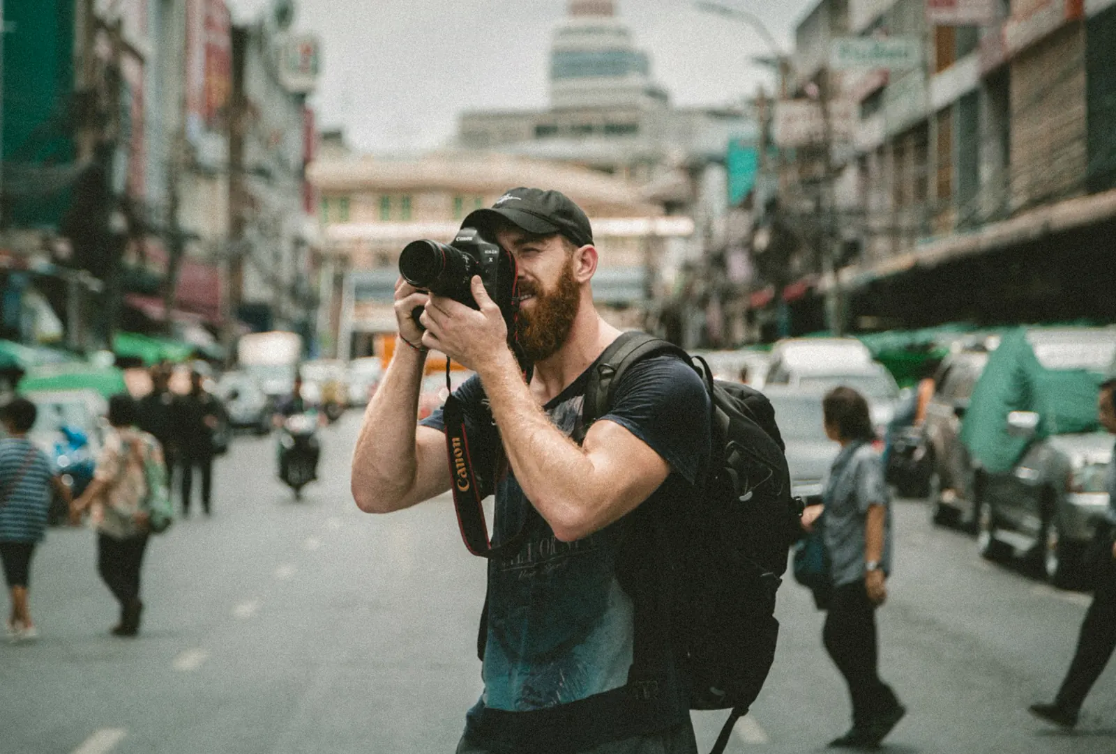 A photographer at work behind a DSLR.