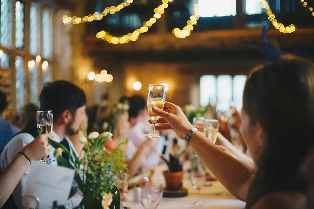 Raised glasses catching the light during a toast.
